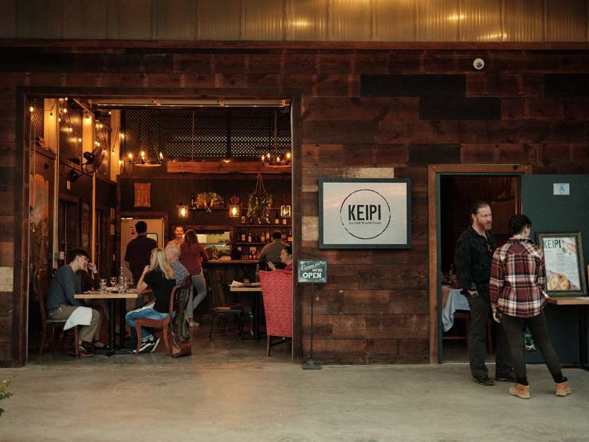 The open entrance to Keipi Restaurant, with people gathering inside and outside.