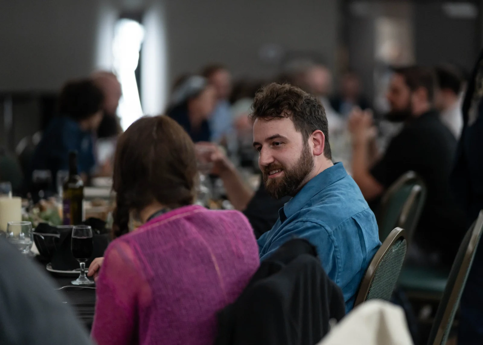 Two guests talk together at a Supra table.