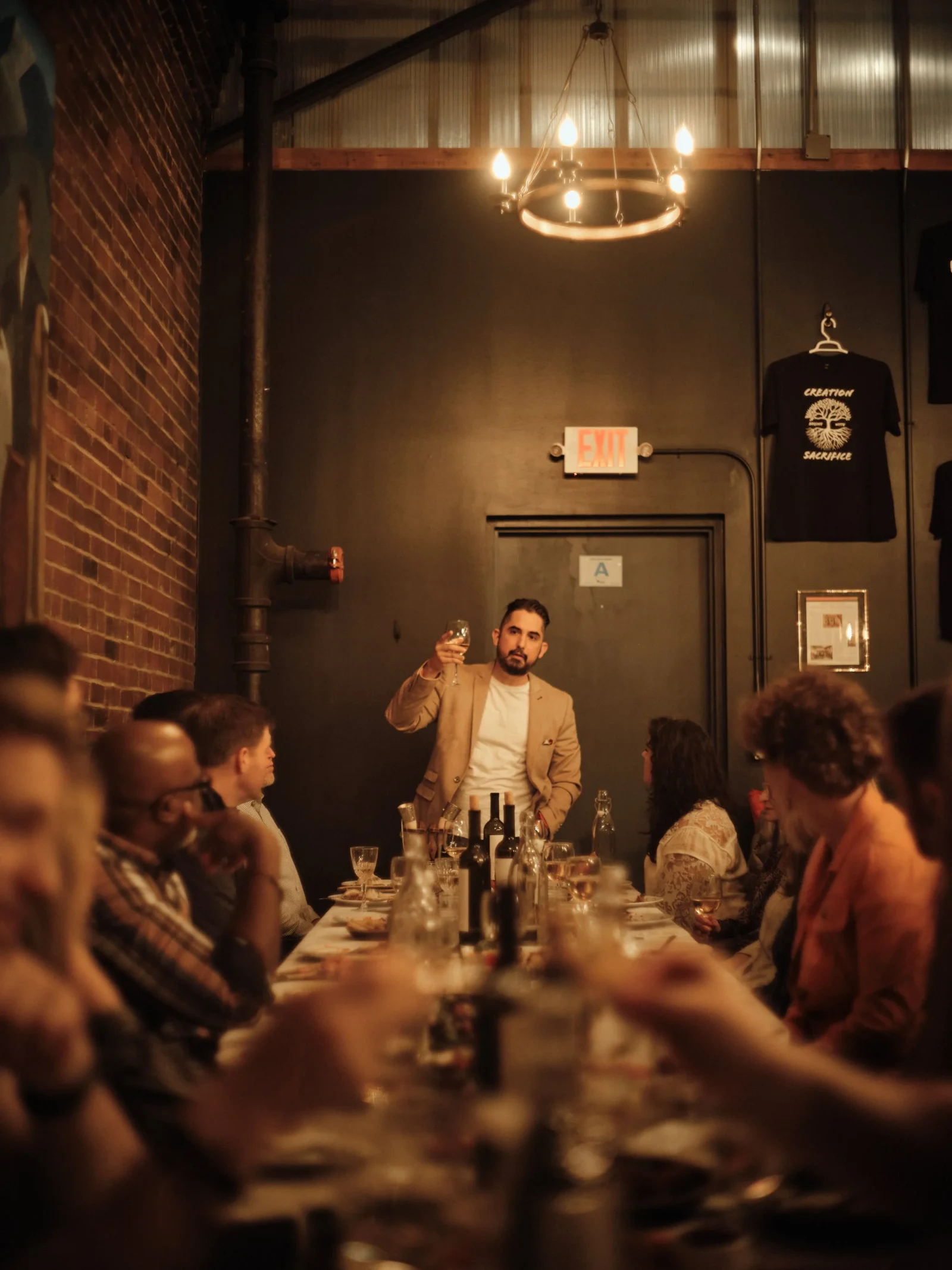 A Tamada raises a glass while guests listen at Keipi Restaurant.