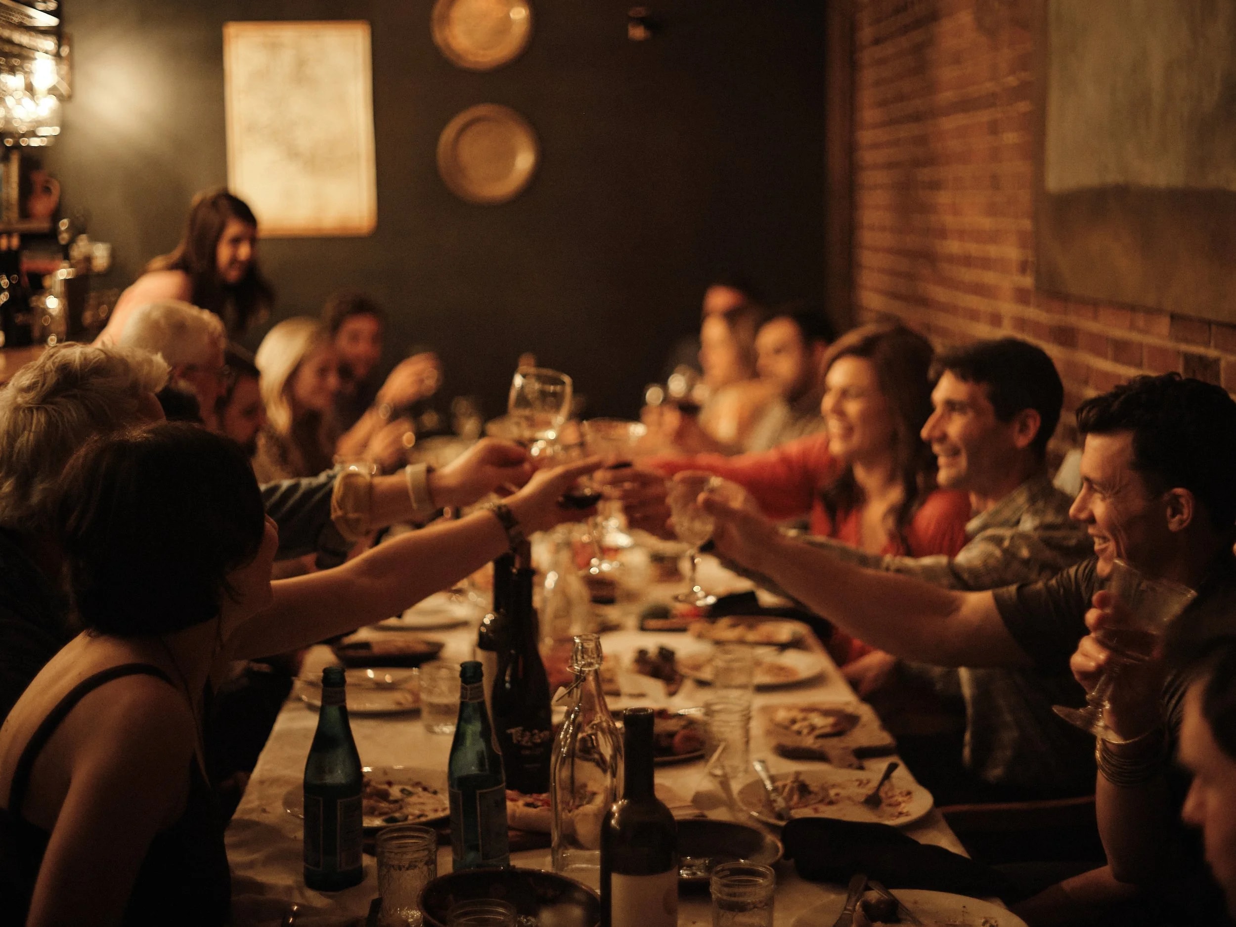 Guests raising glasses around a long table.